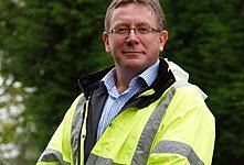 Photograph of a man wearing a flourescent jacket